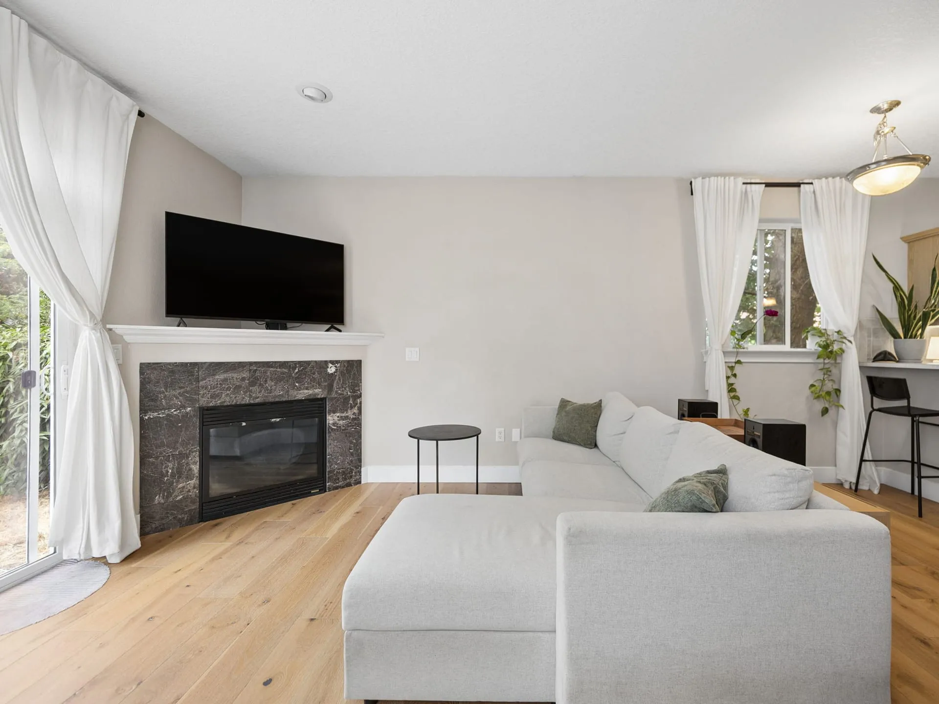 Living room with gas fireplace and new engineered hardwood floors