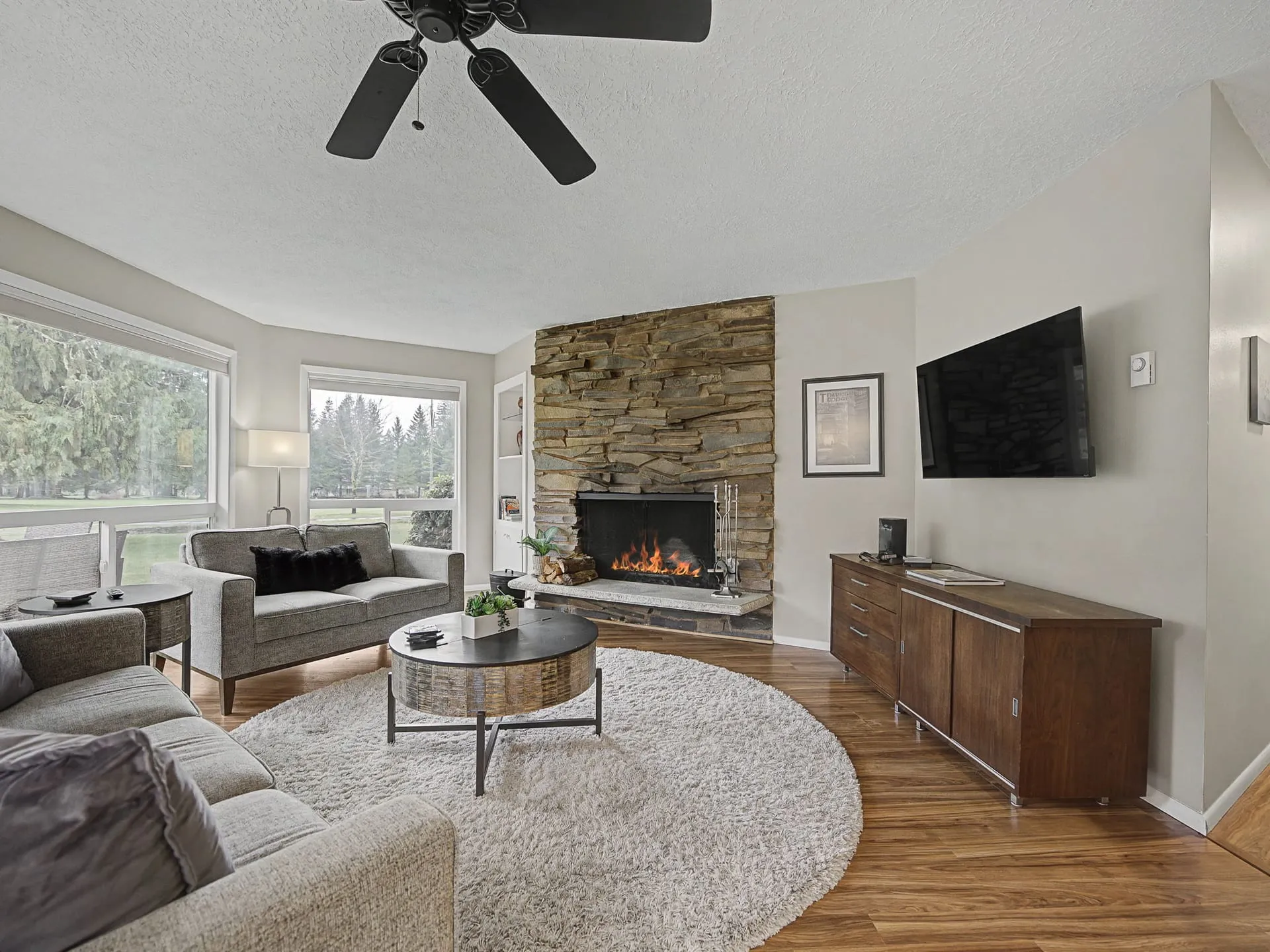 Living room with stone wood-burning fireplace