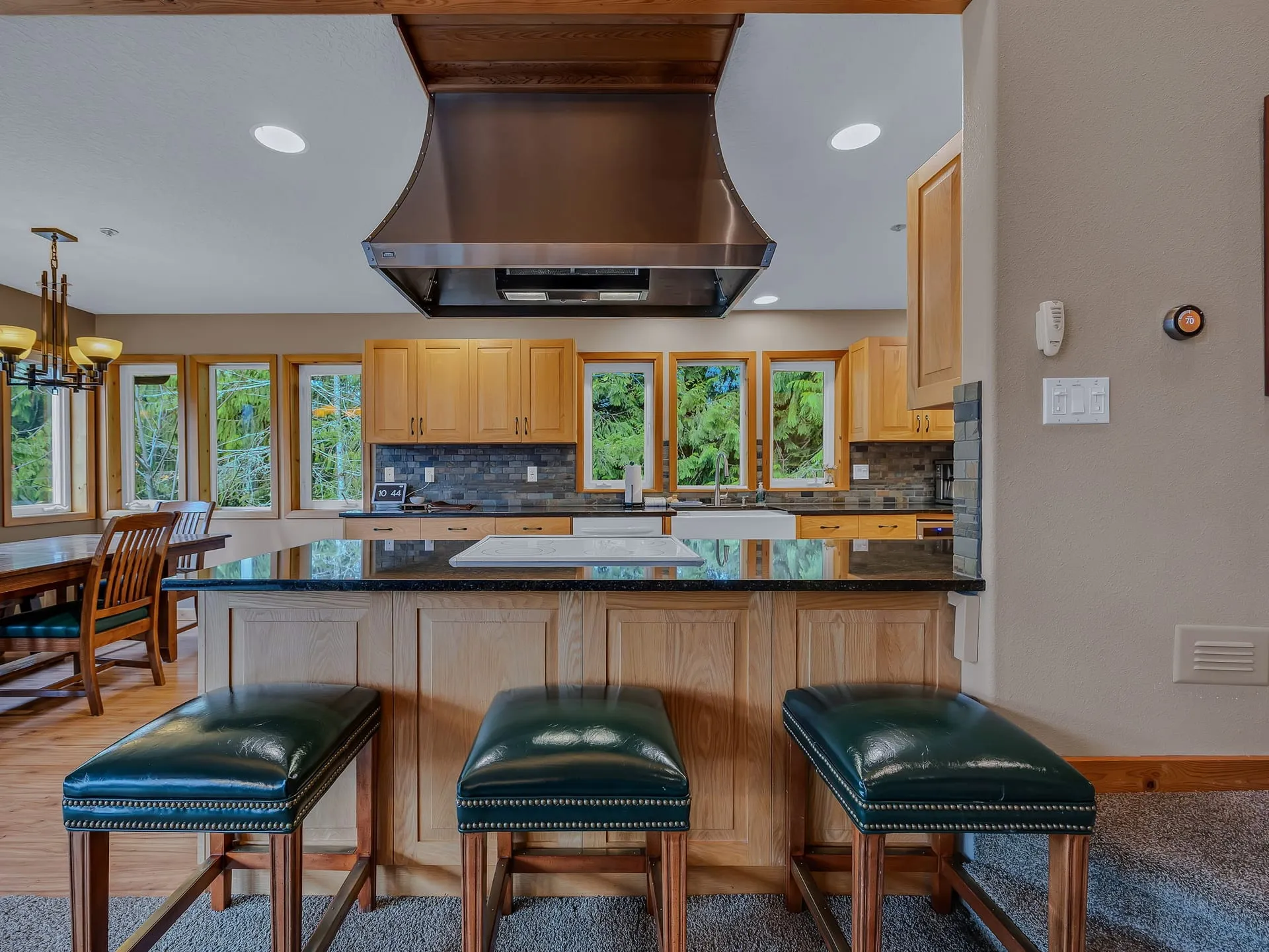 Kitchen with a large island, bar seating and copper range hood