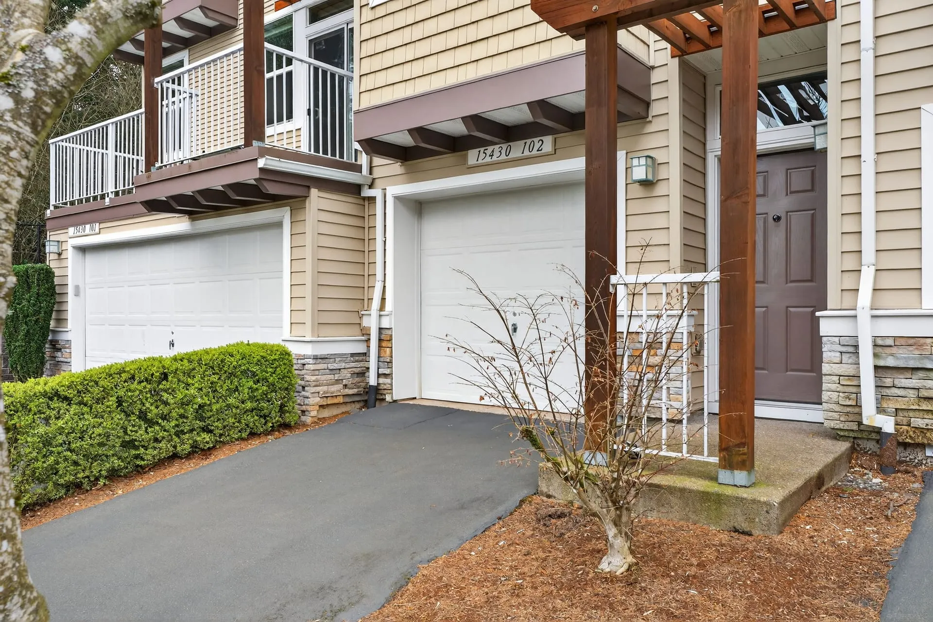 Front of the townhome with entry and garage