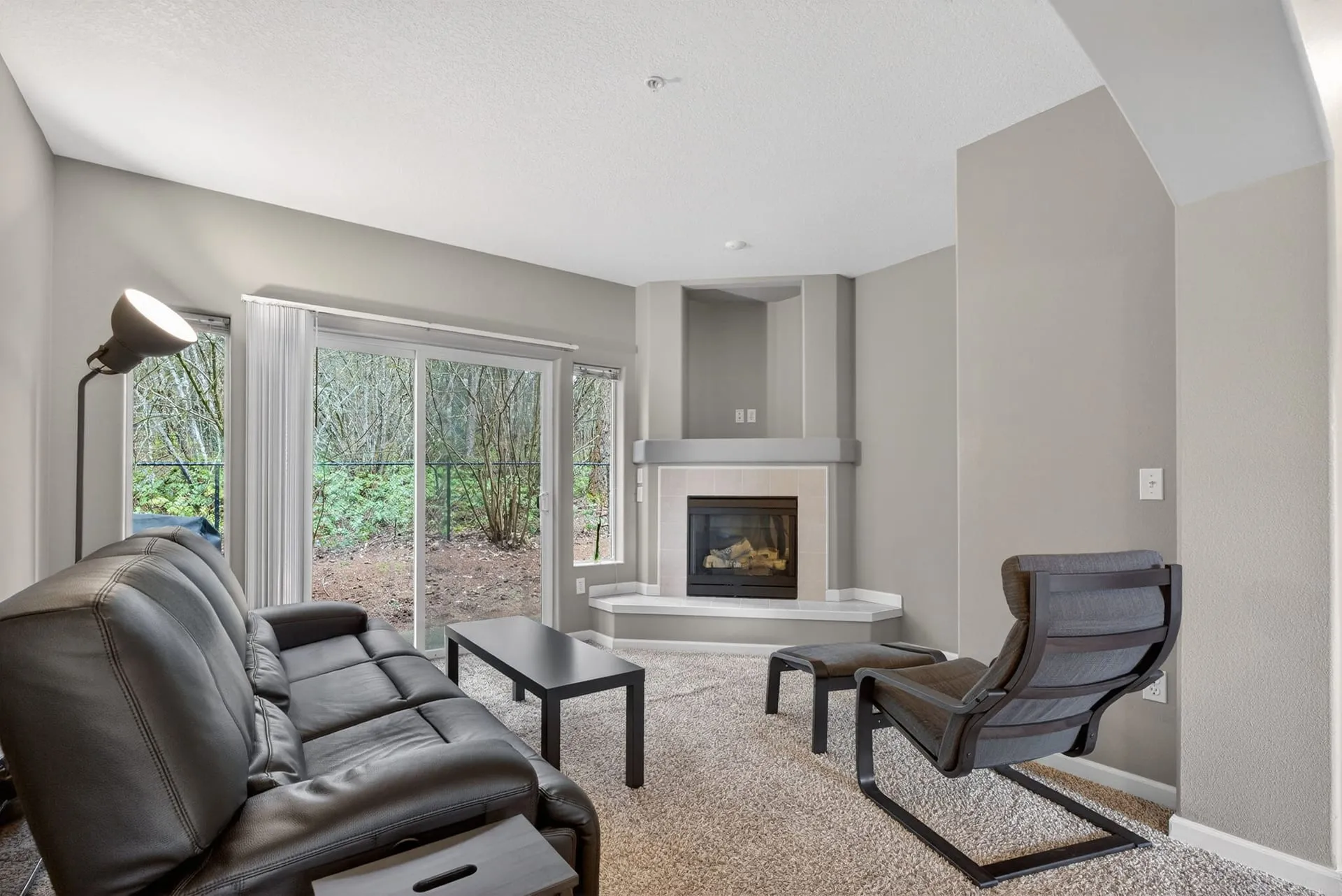 Living room with fireplace and sliding door to the patio