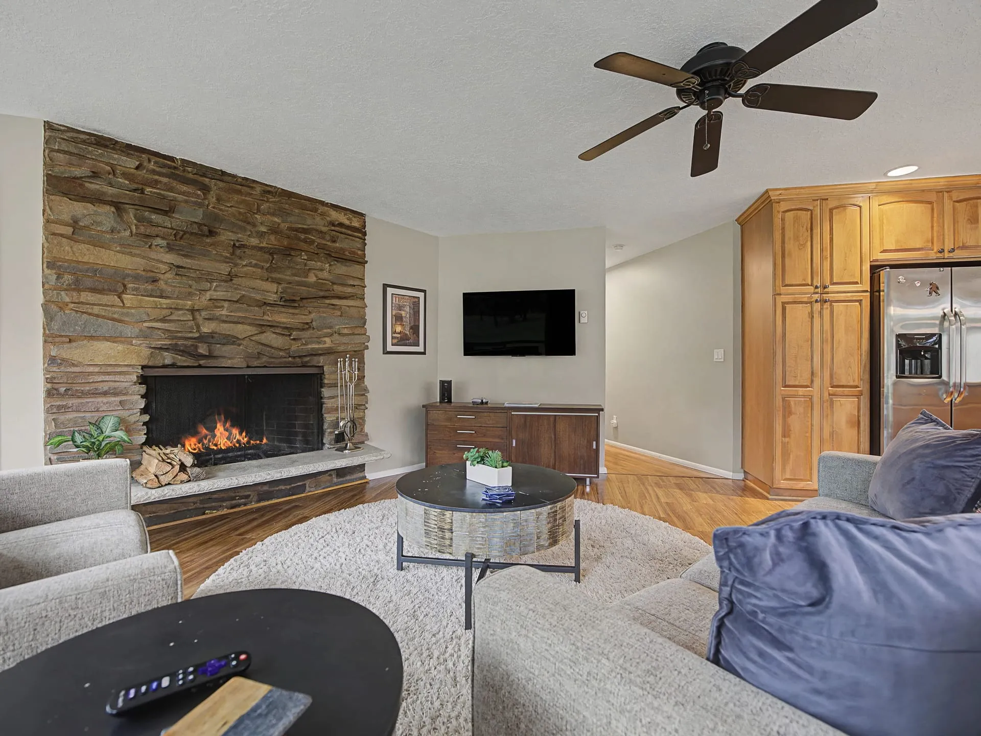 Living room with fireplace and ceiling fan