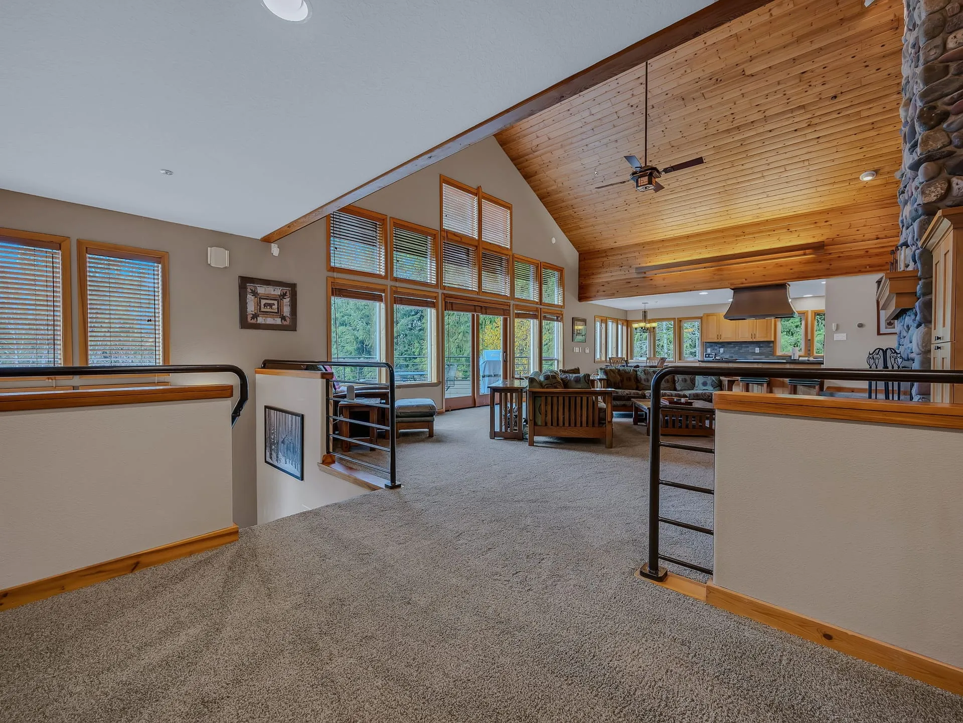 Great room with vaulted ceiling and a wall of windows