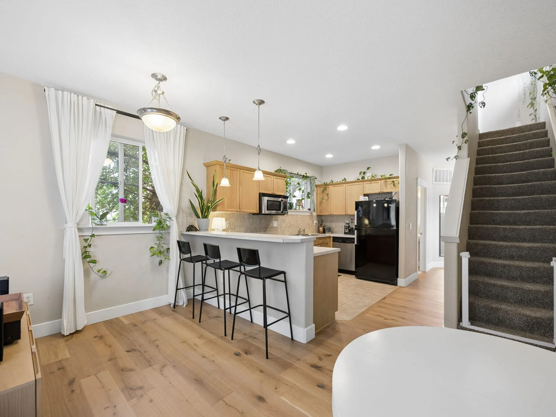 Kitchen with bar seating and stairs to the upper level