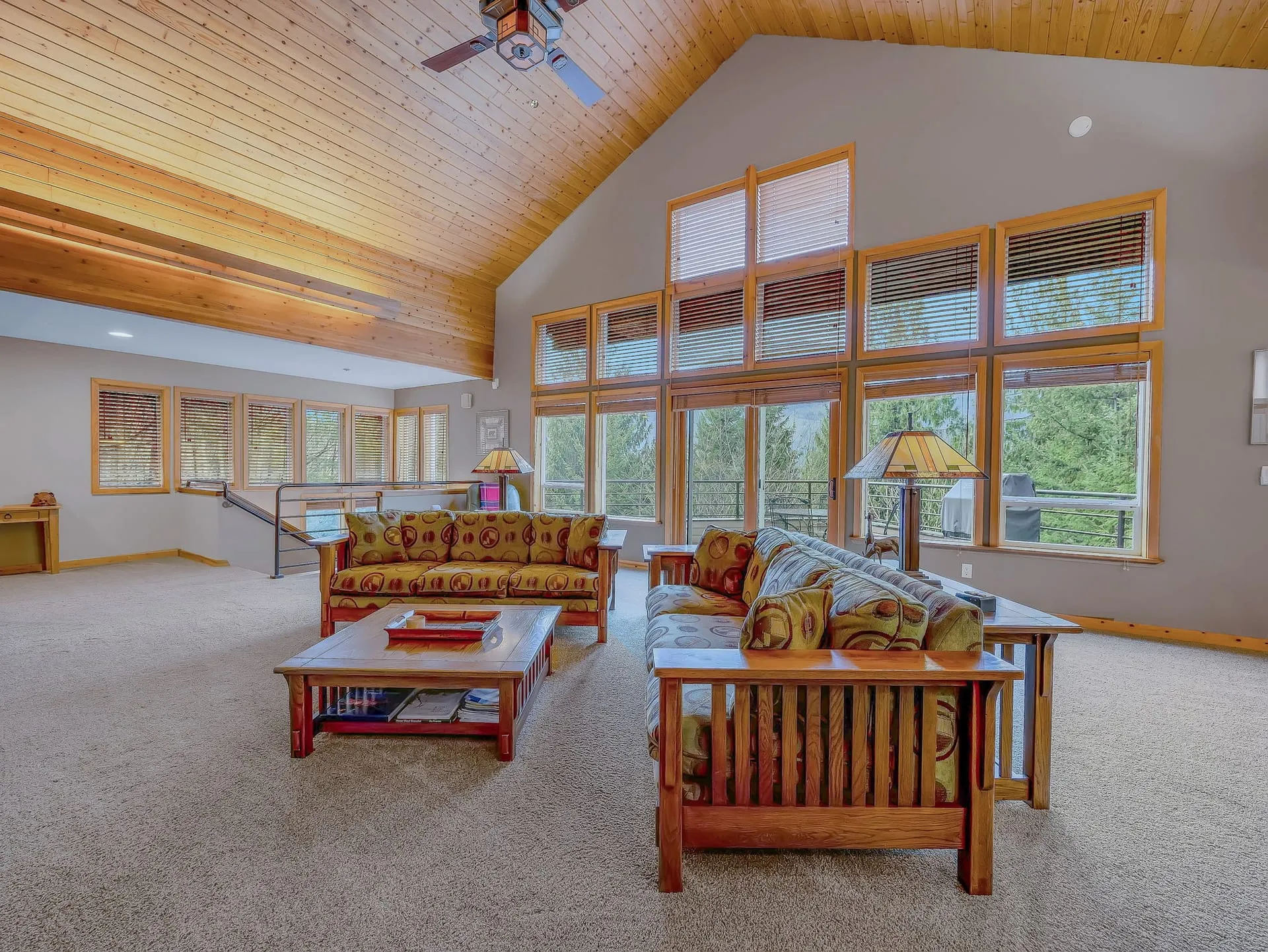 Living area with tall windows looking into the trees