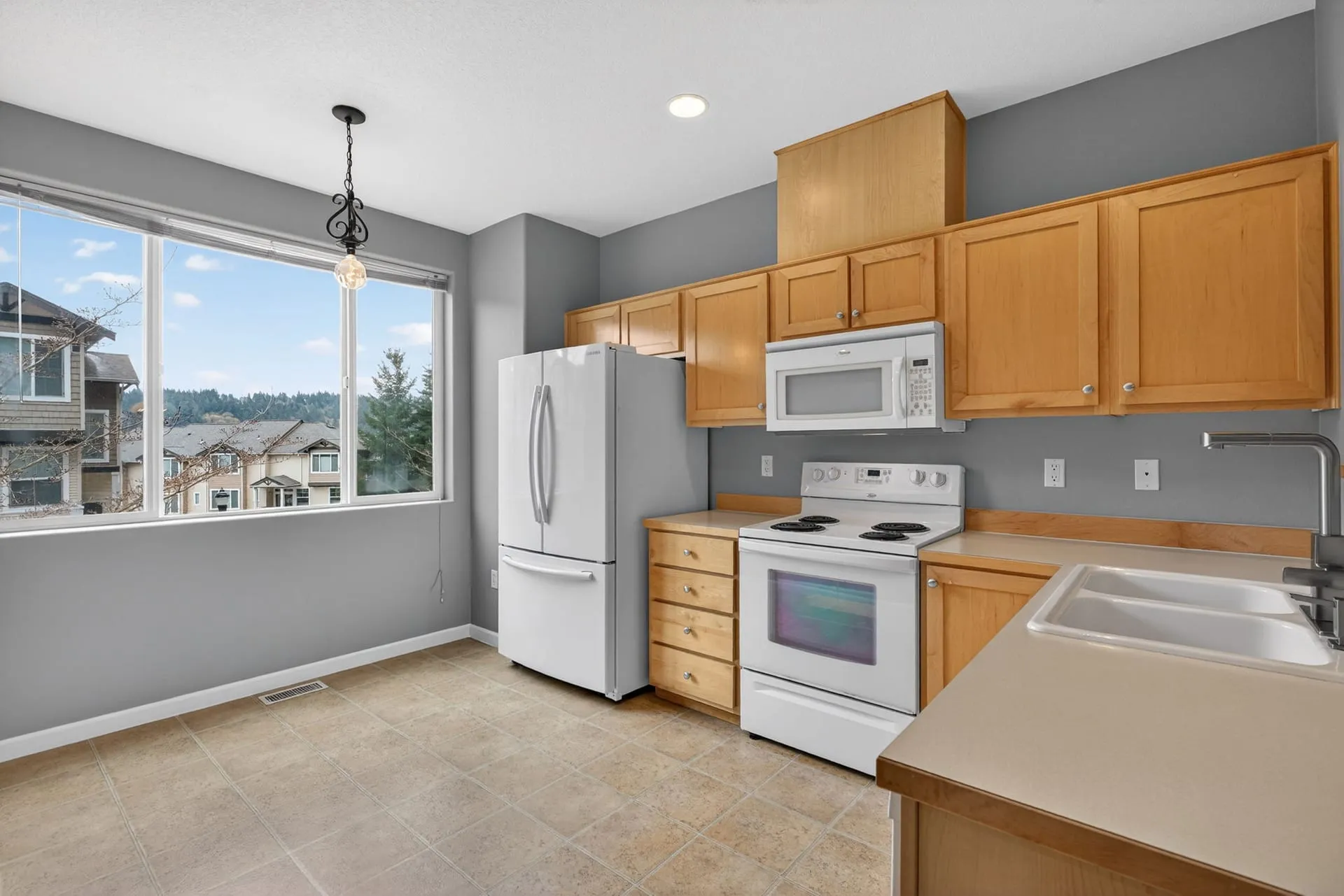 Kitchen with window and white appliances