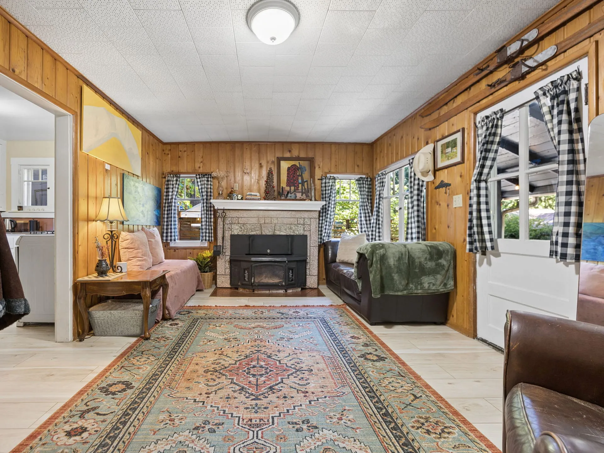Living room with fireplace and checked curtains
