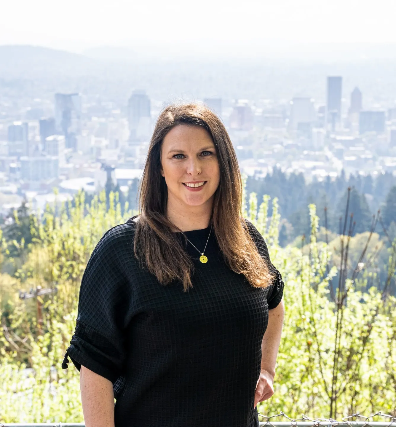 Kelsey Griffith with the downtown Portland skyline behind her